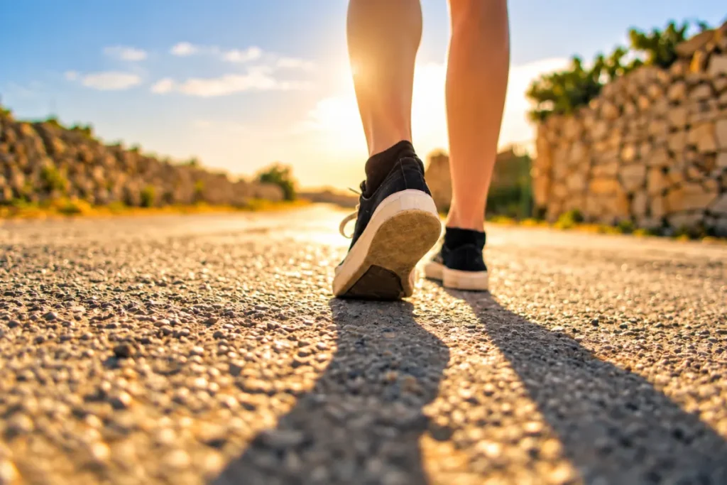 Person walking with difficulty, illustrating changes in walking that may occur with spinal problems